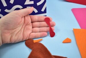 Cut the turkey's wattle out of red felt.