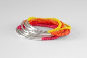 This noodle bead stacking bracelets tutorial is great for anyone, even with NO jewelry making experience. Make a tons of colors for the ultimate outfit!