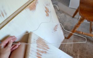 This quick hack makes painting cabinet doors so much quicker. Just grab a metal hanger and let's go! #lifehack