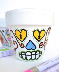 Succulents look super cute in these DIY sugar skull flower pots. Great for Halloween but colorful decor perfect for all year 'round!