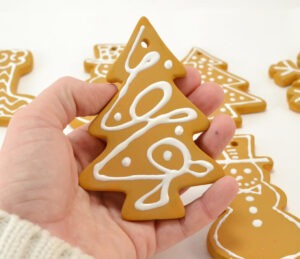 These iced cookie ornaments will make your tree super sweet and last for years. See how to turn ceramic blanks into fantastic cookie ornaments!