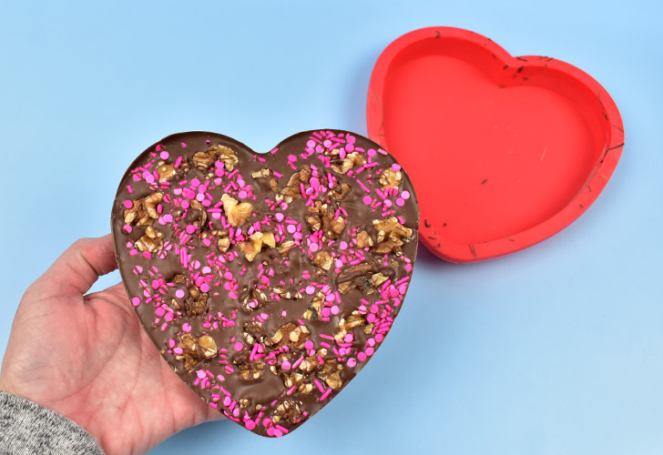 Place the mold on a flat surface and allow the Valentine chocolate bark time to set up. When the bottom of the mold is cool to the touch, gently peel the mold away from the chocolate bark heart.