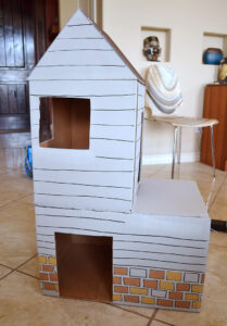 Give kitty something to purr about with their own cardboard cat mansion from upcycled materials!