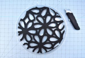 Remove your cut shape from the doormat and test the fit inside of your stepping stone mold. Trim where necessary for an easy fit.