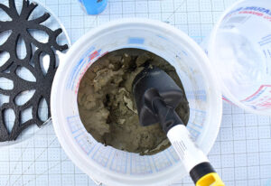 In a plastic mixing bucket combine your sand/topping mix and water until you form a mixture that is similar to a very thick milkshake.