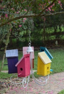 This birdhouse chandlier is a great way to repurpose old lighting! Birds get a new home and the garden gets some quirky color!
