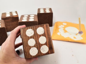 Turn untreated 4x4 lumber into a fun lawn dice game. Use a 5 gallon paint bucket and it's HUGE fun!