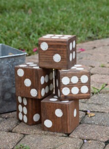 Turn untreated 4x4 lumber into a fun lawn dice game. Use a 5 gallon paint bucket and it's HUGE fun!