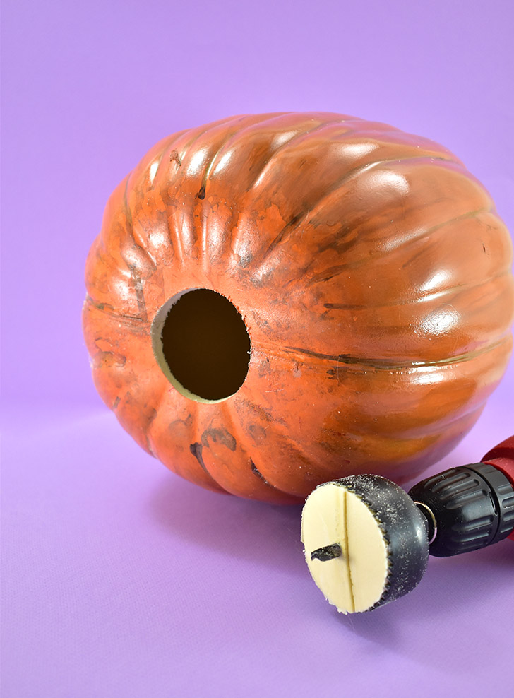 Measure the size of your Himalayan Light Base. Cut a while in the bottom of the fake pumpkin, directly in the center. You can use a hot knife or a craft knife. If you have a hole saw, however, it will make quick and neat work preparing your pumpkin to be lit.