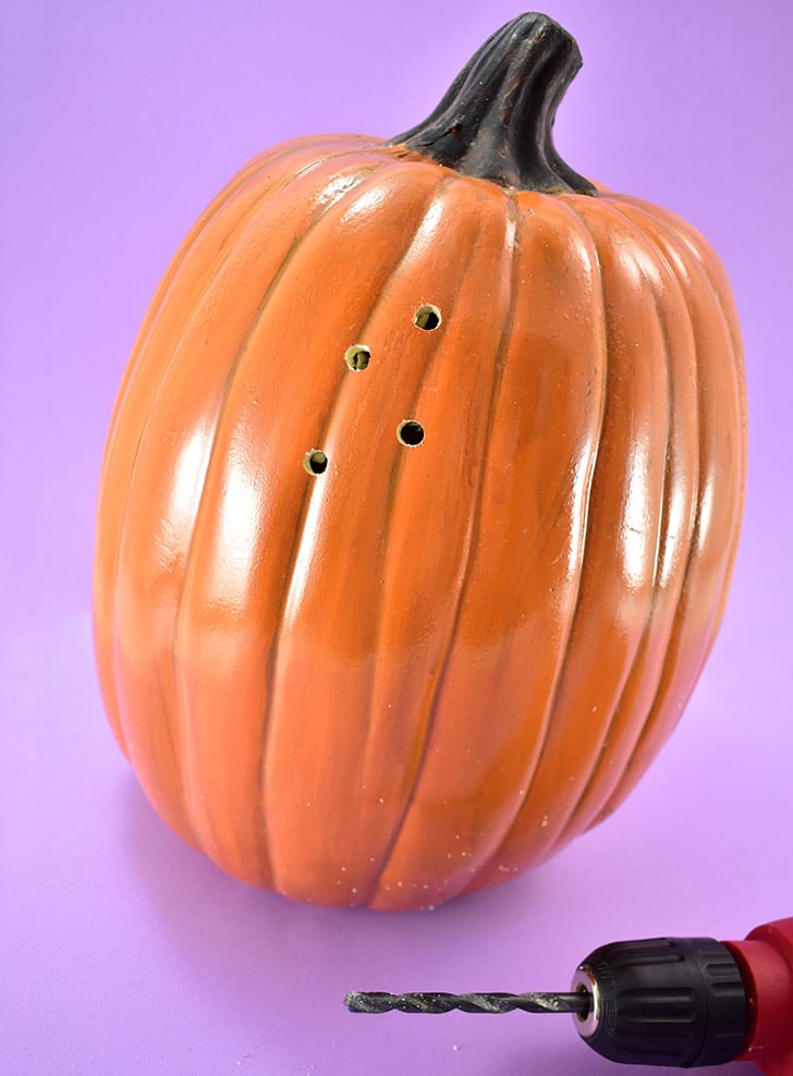 Grab a drill bit that is the size of the holes you'd like in your pumpkin light. Load into the drill and begin randomly drilling holes all around the pumpkin.