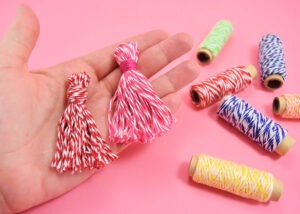 These 5 minute baker's twine tassels are so adorable and cost about 33 cents apiece - seriously why buy when DIY is so cheap?!?