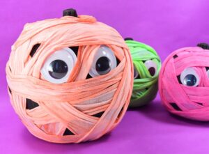 These colorfully cute wrapped mummy pumpkins are beyond adorable and so easy to make! What a fun, no carve Halloween craft!