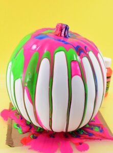 These colorful, drippy no carve pour art pumpkins are super easy and use washable paint making it the perfect Halloween kid craft! Click through for a few tips and tricks so you can achieve pretty results!