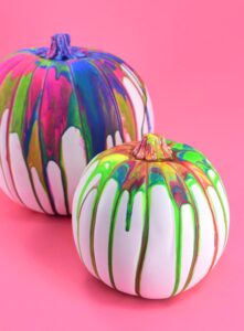 These colorful, drippy no carve pour art pumpkins are super easy and use washable paint making it the perfect Halloween kid craft! Click through for a few tips and tricks so you can achieve pretty results!