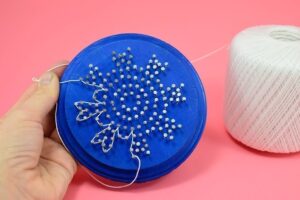 Using wood plaques these awesome string art snowflake ornaments are amazing!