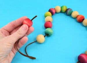 Save your tabletops and counters from unnecessary burns with an easy to make wooden bead trivet. Paint, dye or leave the beads natural to match any kitchen