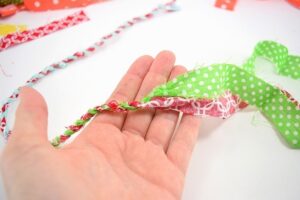 Learn how to turn your scrap material into simple and adorable fabric twine. Make something cute and bust your craft stash at the same time!