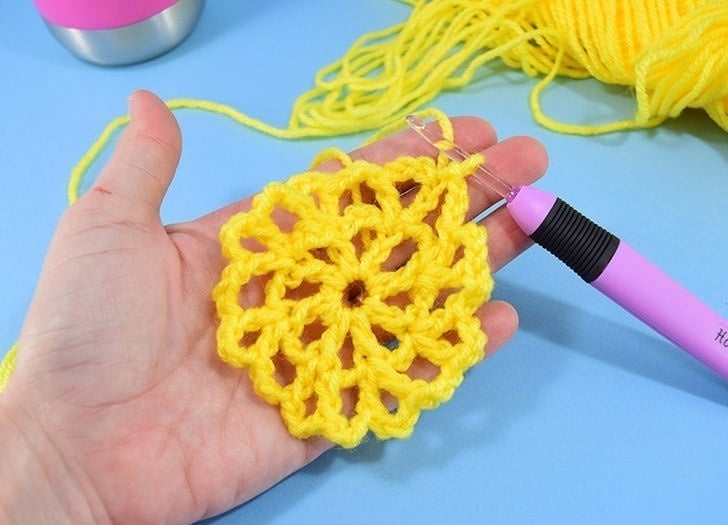 Hate holding on to your water bottle? This crochet water bottle holder is a great use of scrap yarn and it keeps your water nearby and your hands free!