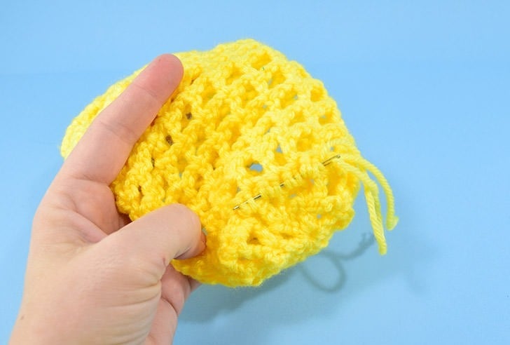 Hate holding on to your water bottle? This crochet water bottle holder is a great use of scrap yarn and it keeps your water nearby and your hands free!