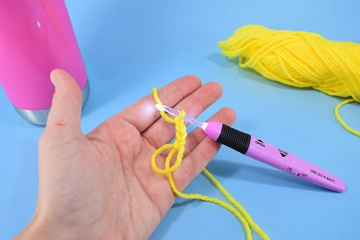 Hate holding on to your water bottle? This crochet water bottle holder is a great use of scrap yarn and it keeps your water nearby and your hands free!