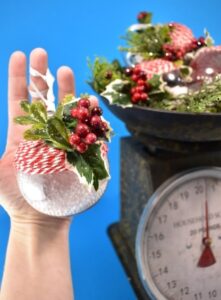 Craft supplies from the bargain bin become simple yet gorgeous baker's twine and holly rustic Christmas ornaments you can make in only 5 minutes apiece!