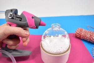 Craft supplies from the bargain bin become simple yet gorgeous baker's twine and holly rustic Christmas ornaments you can make in only 5 minutes apiece!