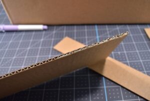 Don't you just love this "hissing booth" cardboard cat hideaway? All you need is a moving box and some cardstock to make this adorable kitty play place.