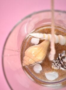 Add a lovely beach-inspired touch to your home decor turning your ocean vacation finds into gorgeous DIY seashell candles.