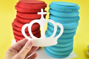 Paint 24 wood crowns white, or your choice of color that will stand out against your solid checkers well and allow to fully dry.