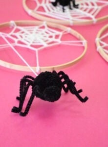 Turn embroidery hoops into adorable Halloween decor by adding crochet spider webs to them. Add in some pompom spiders and it's almost too cute!