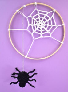 Turn embroidery hoops into adorable Halloween decor by adding crochet spider webs to them. Add in some pompom spiders and it's almost too cute!