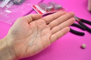 Snip Christmas ornament hooks, or a fine gauge wire into 1-inch segments.