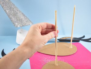 Once fully dry, hot glue dowels onto the backside of the ears and into the bottom side of the unicorn horn and allow to dry.