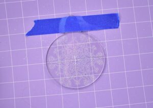 Remove the paper from the second side of the ornament and using the outline place it on the mat.