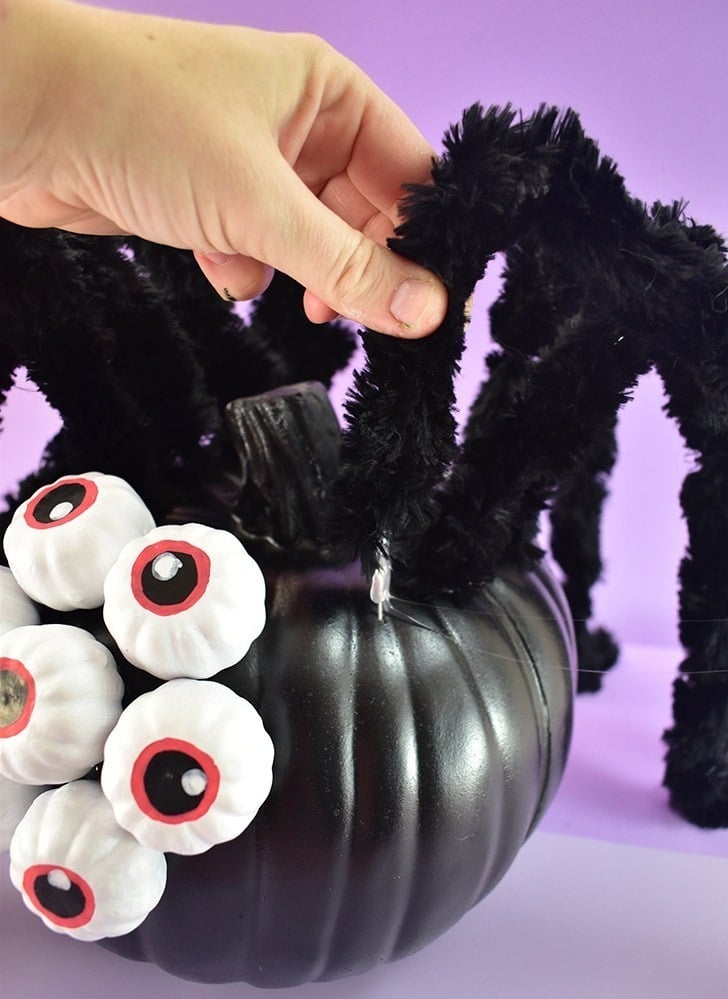 Poke the steel wires into the body of the pumpkin, 4 on each side, nearer the back.