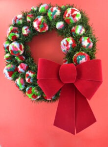 Want to add a little bit of color to your otherwise traditional Christmas decor? This pine and pompom wreath is gorgeous, easy and inexpensive!