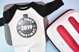 Grab an adorable raglan baby onesie and add our free annual Christmas SVG design to adorn it.