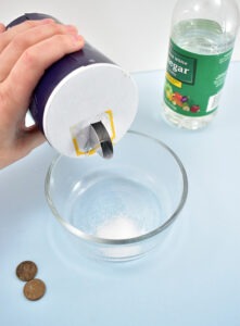 In a small non-metal bowl pour 1 teaspoon of table salt and 2 tablespoons of vinegar.