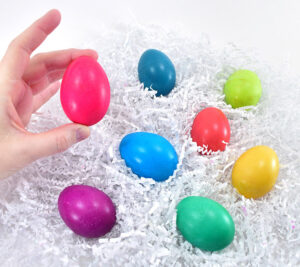 Finish your eggs a pretty sheen with vegetable oil. It's amazing a drop of vegetable can do for pretty Easter eggs. Once the dye has dried place a few drop of vegetable oil onto the surface. Rub the oil into the shell with your hands and then use a paper towel to buff away the excess. Once done the egg should have a lovely shiny sheen but no longer be slippery. This makes bright colors really pop!