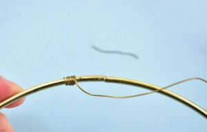 Once you've wrapped approximately a quarter of an inch of the tail snip away the excess tail.