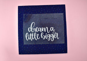 Place the design carrier sheet up on the mouse pad where you'd like the design to be.