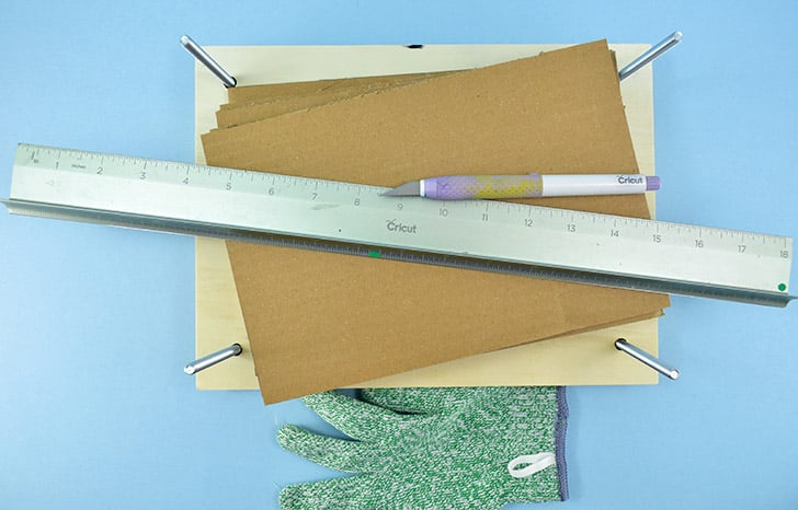 Using a craft knife and a straight edge cut pieces of cardboard to approximately 7 x 10", or whatever fits best within the bolts.