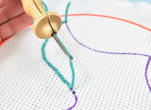 Pulling the needle too far away from the top of the fabric will pull out one or more of your previous stitches. Be sure to keep the needle close to the fabric as you move on to the next stitch.