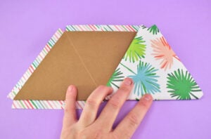 Fold the scored sides of the piece you just glued down and apply pressure along it. Fold until the chipboard meets itself.