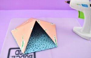 Repeat for the 3 other connected sides. Once fully attached, use hot glue like caulk around the edge to make sure the 2 pieces are completely glued together.