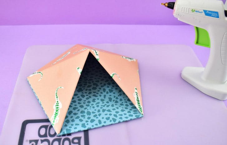 Repeat for all 4 connected sides. Once fully attached, use hot glue like caulk around the edge to make sure the 2 pieces are completely glued together.