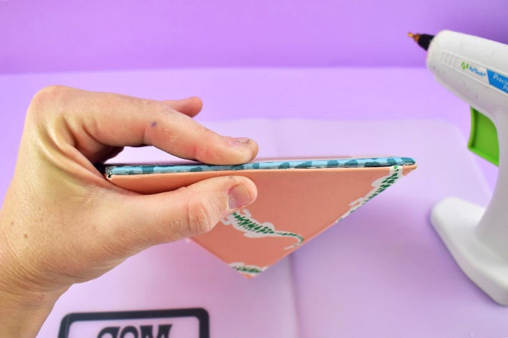 Apply a line of hot glue to one side of the pentagon flat piece. Place the 3d top piece in place and hold until the glue fully cools and sets.