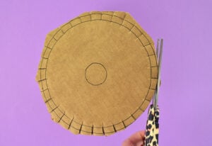 Using a pair of sharp scissors cut each slot around the DIY Kumihimo disk first. Next trim around the outer circle to form the disk-shape.