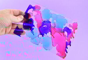 Pick up the glass and move around so that the colors merge and bleed into one another. You want to cover as much of the glass as you can in ink.