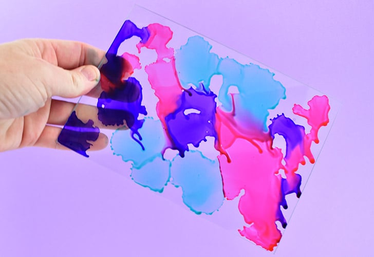 Pick up the glass and move around so that the colors merge and bleed into one another. You want to cover as much of the glass as you can in ink.